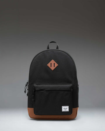 Herschel Heritage Youth Backpack in Black with Saddle Brown rubber strap detail.
