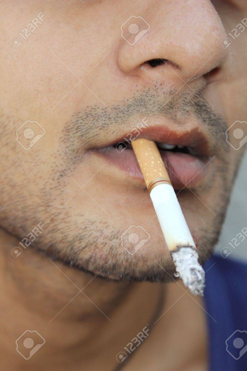 Close-up Shot Of A Guy With Cigarette In His Mouth Stock Photo, Picture and  Royalty Free Image. Image 13262401
