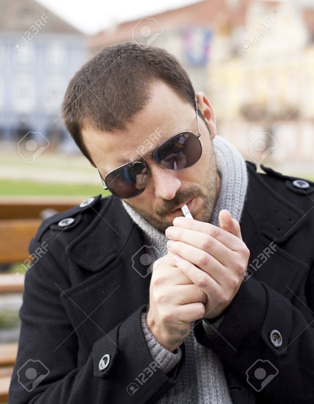 Man Lighting A Cigarette Stock Photo, Picture and Royalty Free Image. Image  16726978