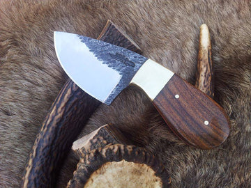 Custom 6-inch hand-forged 1095 steel field dressing knife with rosewood handle.