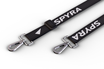 Partial SpyraStrap. Two bucklesand some part of the strap is visible.. The buckles are silver, the strap has a Spyra logo woven into it.