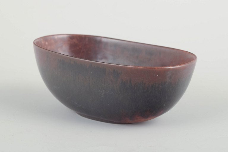 Carl-Harry Stålhane for Rörstrand, Sweden. Oval stoneware bowl with low foot and reddish-brown glaze. Mid-20th century.