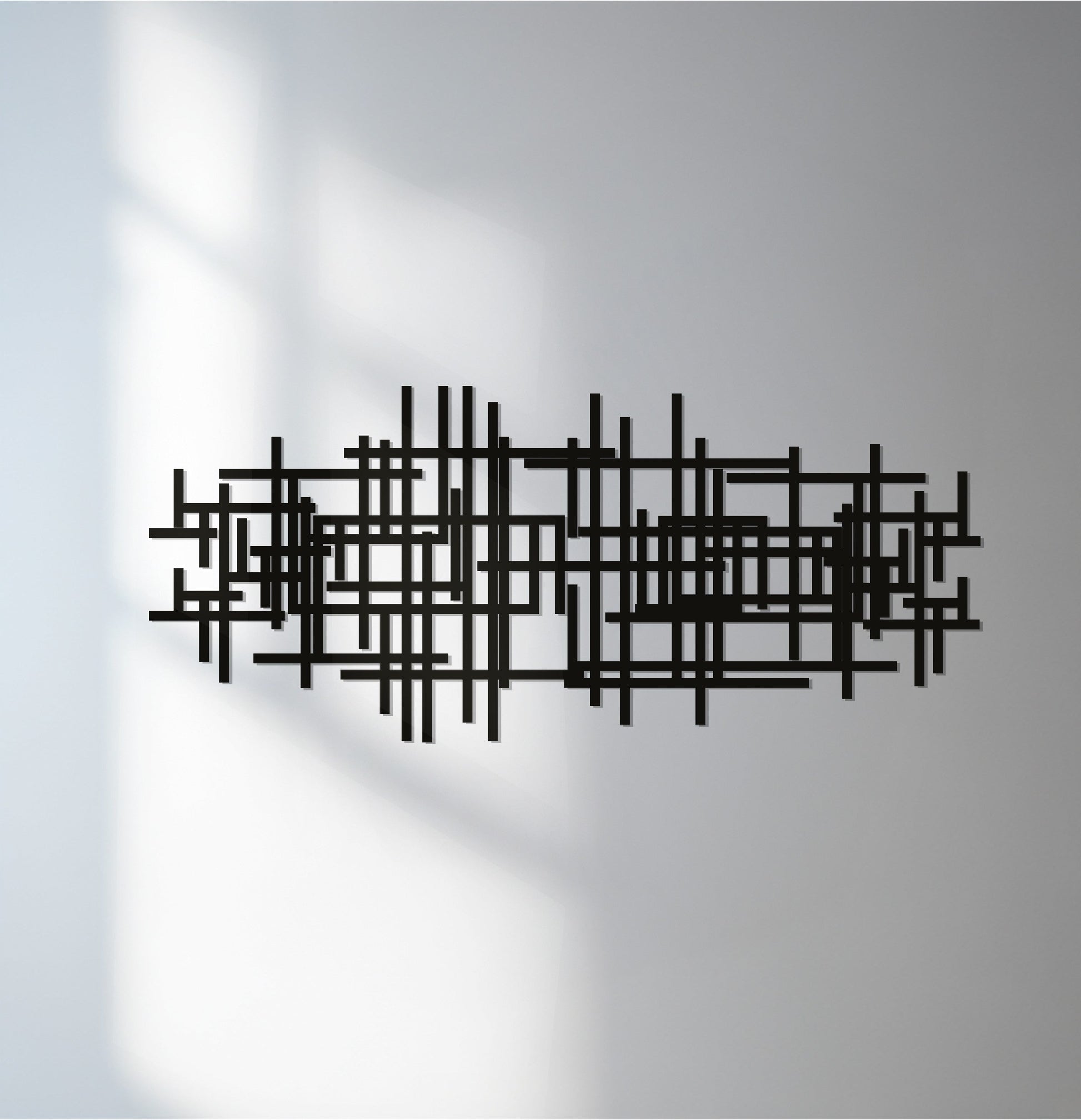 Showcasing the abstract quality of this decorative metal art, the piece features geometric lines in a modern black design, adding an artistic touch to any space.