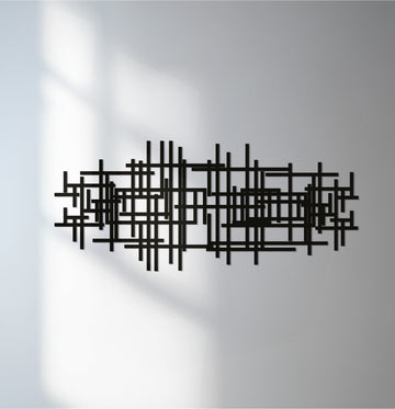 Showcasing the abstract quality of this decorative metal art, the piece features geometric lines in a modern black design, adding an artistic touch to any space.