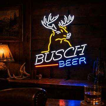 A illuminated glowing neon sign featuring the words "Deer Beer & Bar" in stylized font, accented by two leaping deer silhouettes, glowing amber and yellow.