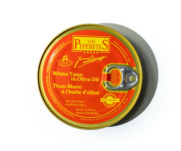 Top-down view of Los Peperetes white tuna tin in olive oil showcasing red and gold label and pull-tab on white background