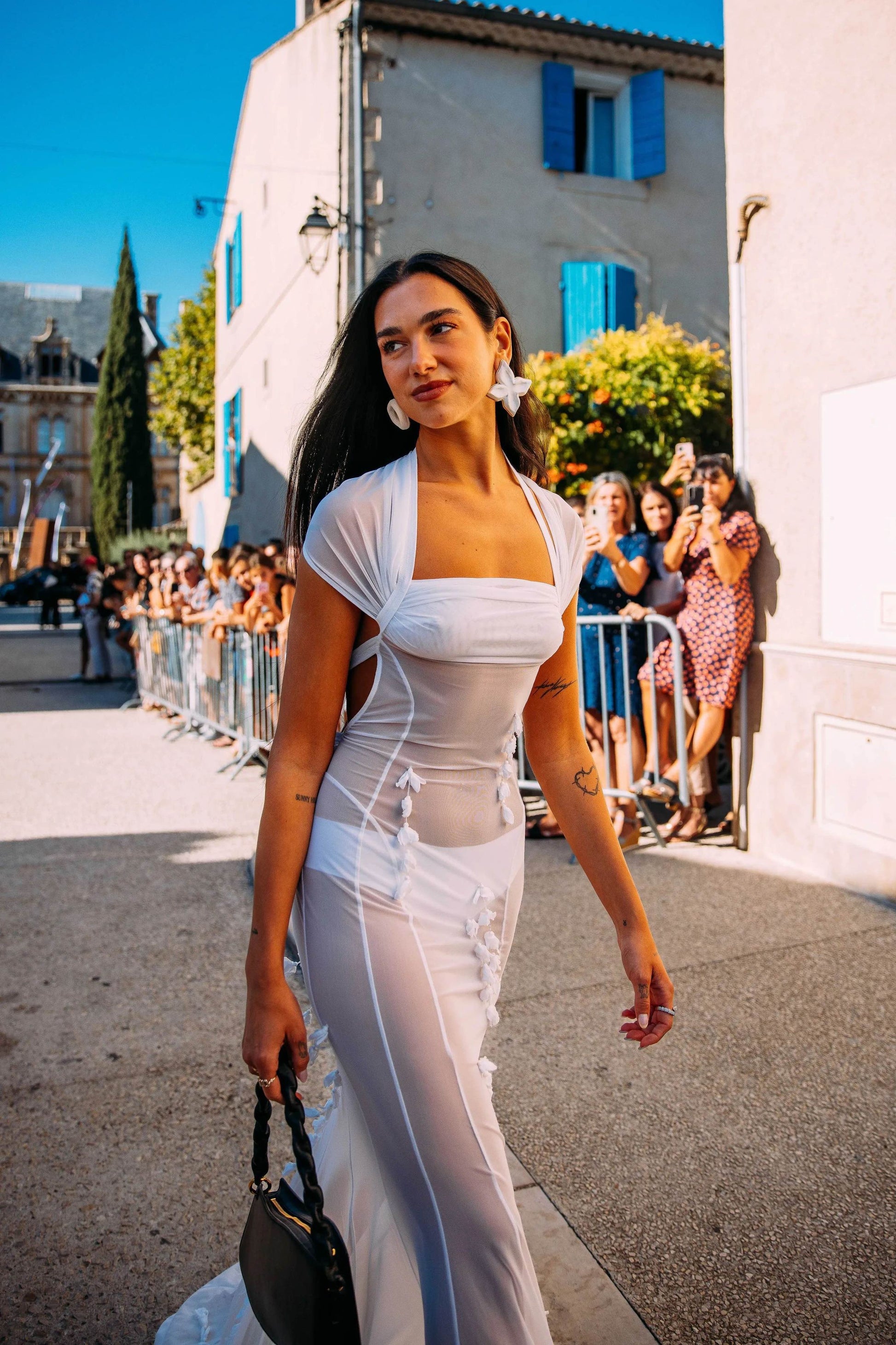 Dua Lipa wore a sheer white dress to the Jacquemus wedding — see photos