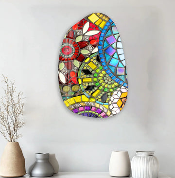 An abstract glass art painting with bold geometric patterns and vibrant colors uses ample negative space to create a striking, modern focal point.