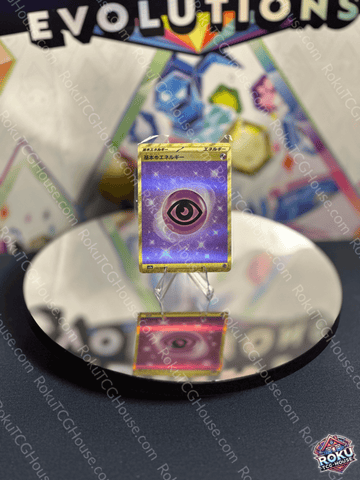 Gold Psychic Energy card from the Japanese SV: 151 set displayed on a reflective surface.