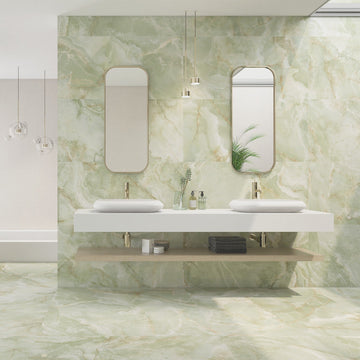 Interior space featuring walls and floors adorned with green marble effect tiles, with a modern bathroom vanity and mirrors.

layout-bathroom