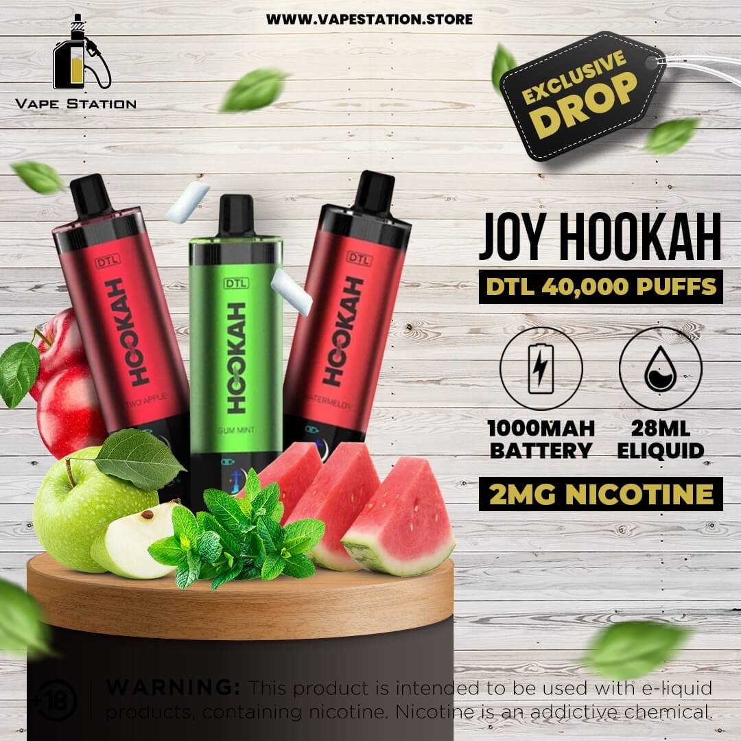 Joy Hookah vape devices with fruit and leaves on a wooden platform, branded as Vape Station.