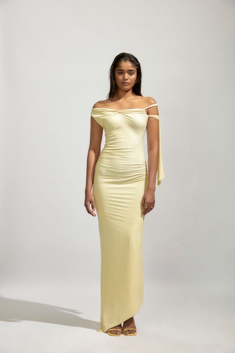 Deme By Gabriella YVETTE Butter Yellow Maxi Dress featuring a flowing fabric and elegant sleeveless design.