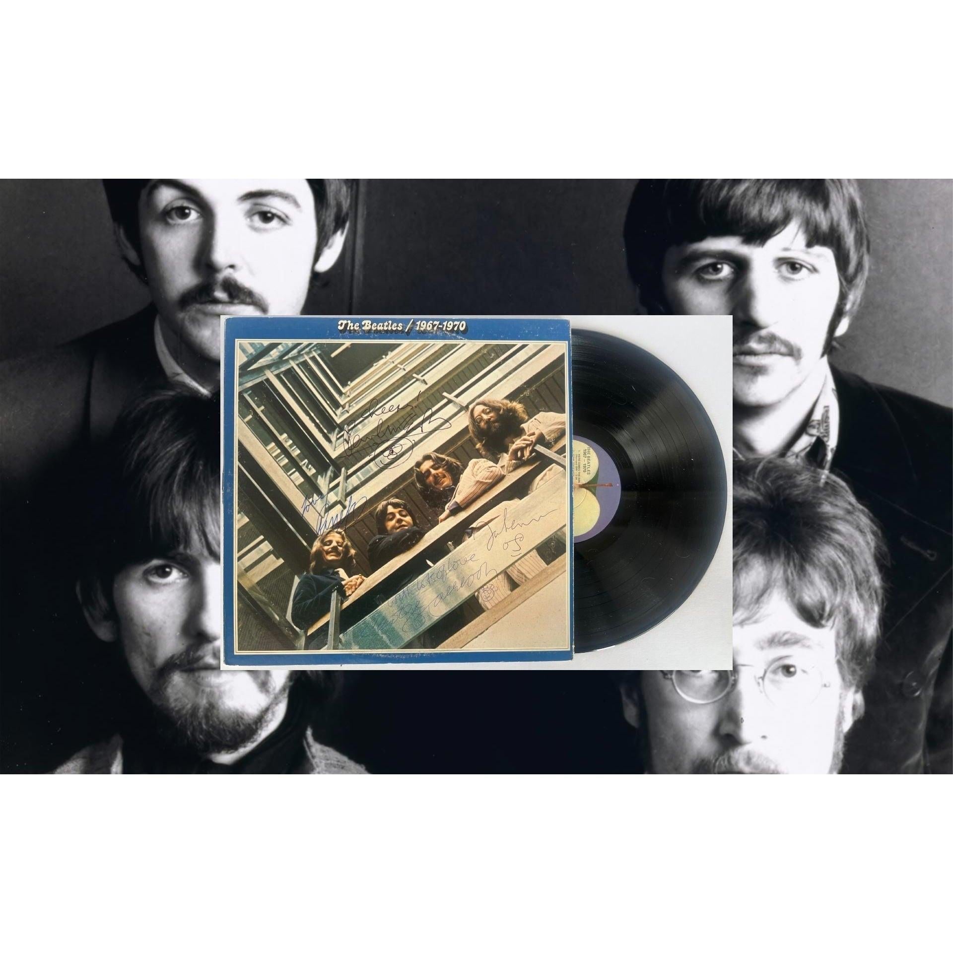 Vinyl record with cover art overlayed on a black-and-white photo of four men.