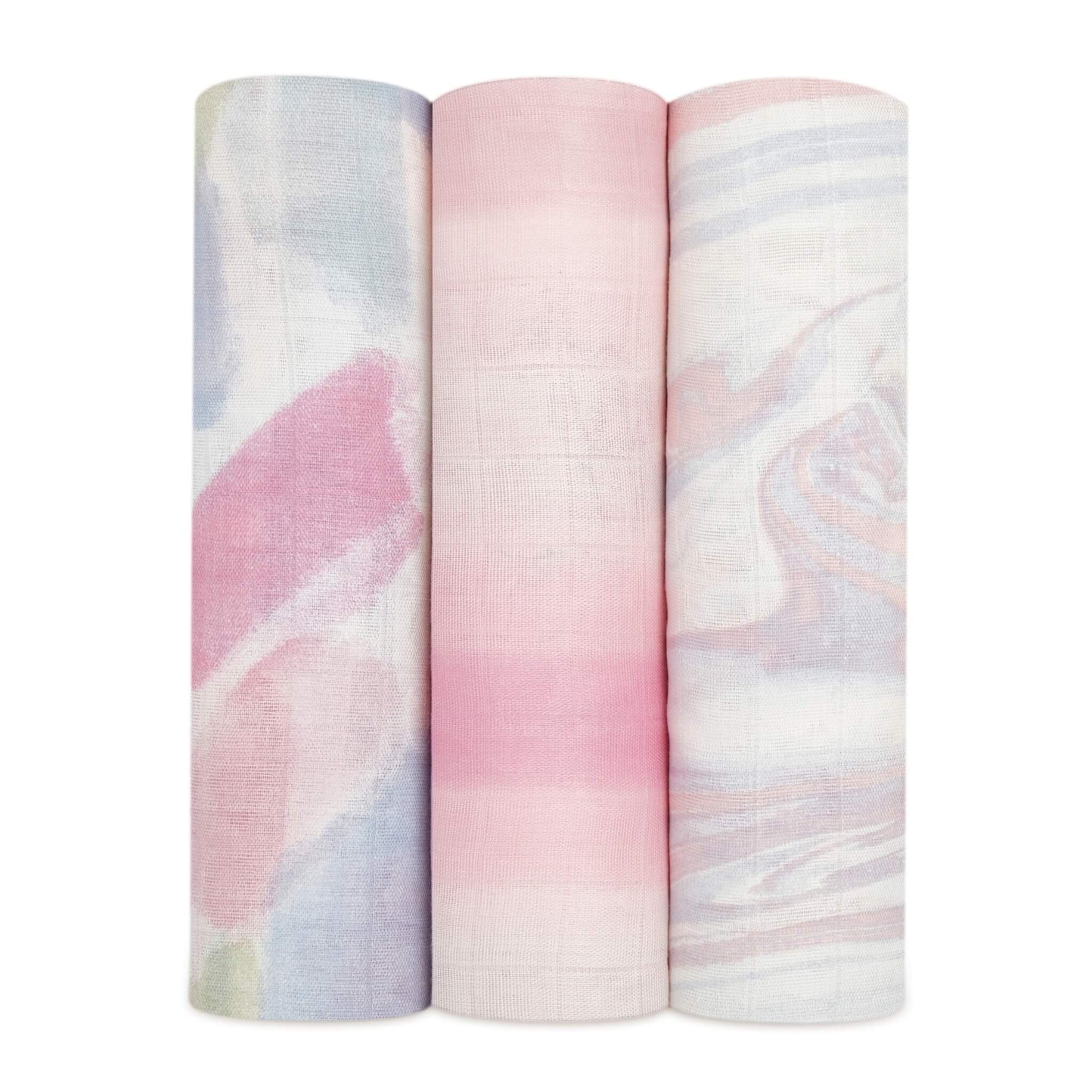 Three aden + anais silky soft muslin swaddles in the Florentine set, rolled to show pastel abstract prints.