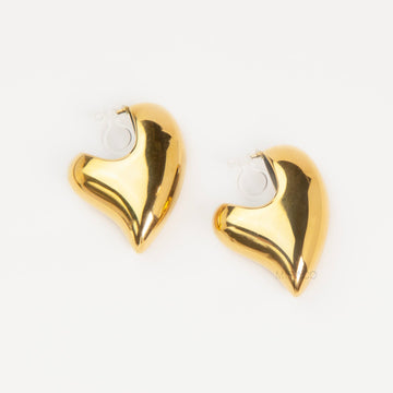 Chunky gold heart-shaped clip-on earrings with clear invisible resin backings for non-pierced ears.