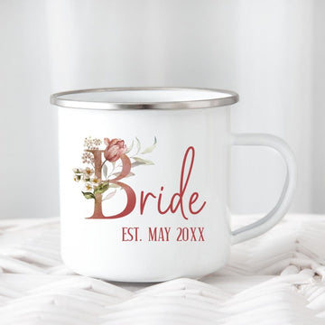Customizable floral bride coffee mug souvenir for fiancée, wife, spouse, BFF or bestie on your wedding or anniversary. Great idea for engagement announcement, bachelorette party, bridesmaid gift idea, rehearsal dinner tea cup, and after wedding party gift. This cute getting ready present is a perfect idea for soon-to-be daughter-in-law, future Mrs. bride or as a honeymoon vacation souvenir. Personalize with date for a special touch.