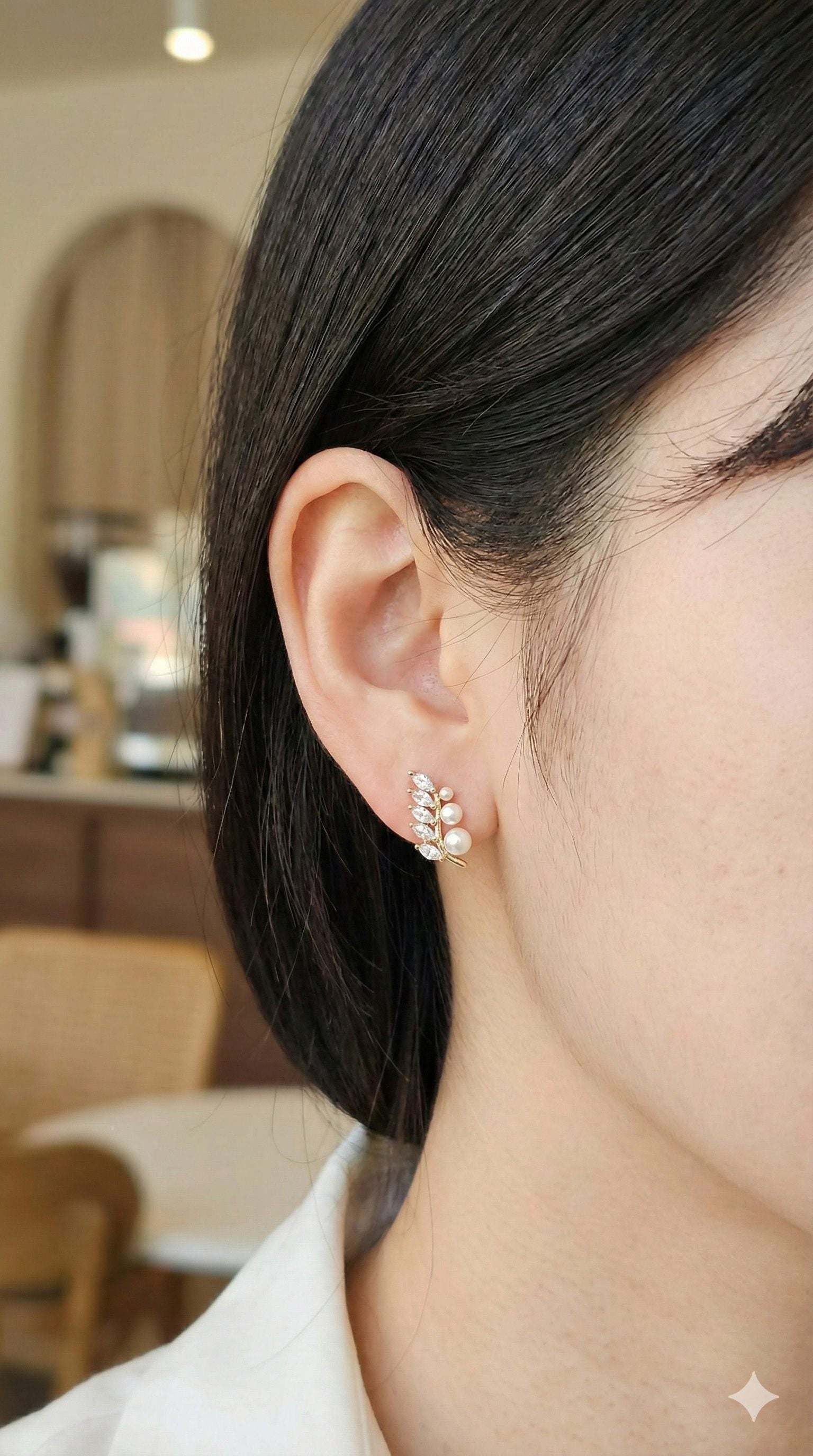 young woman wearing gold-plated hypoallergenic earrings, showing their anti-tarnish shine suitable for sensitive skin and daily wear