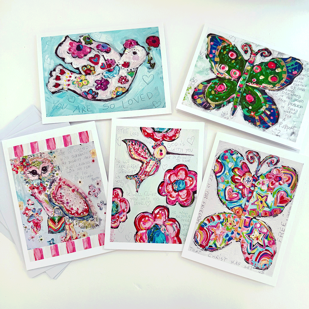 A collection of five colorful blank notecards with various designs, including floral patterns and an owl, displayed with their respective envelopes.