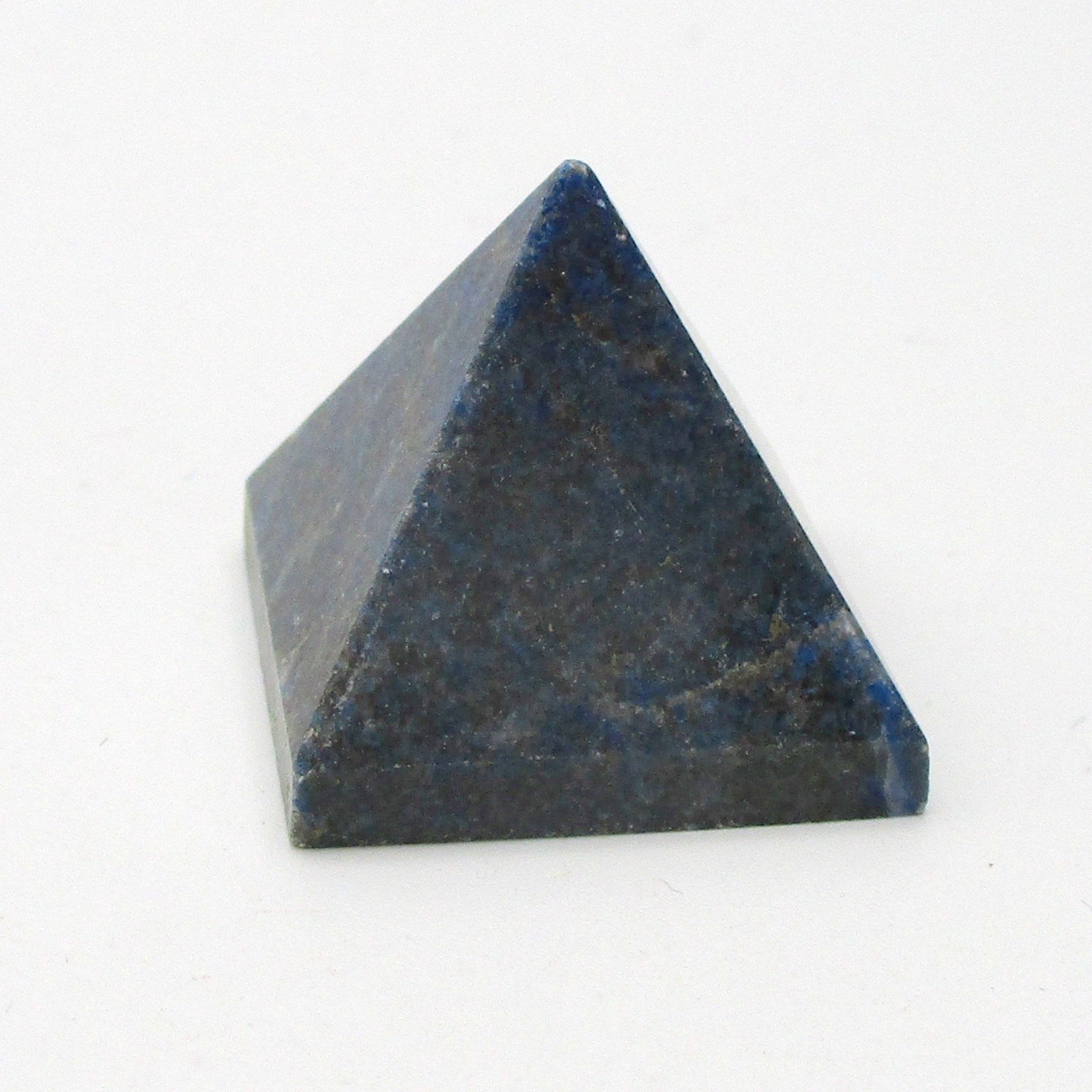 A blue Lapis Lazuli crystal pyramid with a polished surface on a white background.