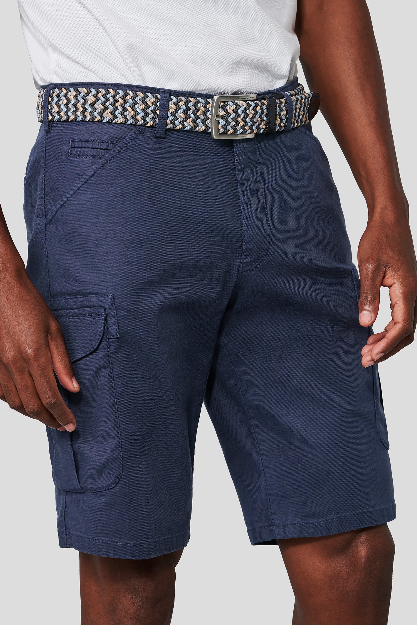 Navy cargo shorts with a belt on a plain background